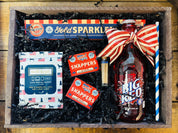Nifty Package Co. Vintage Americana Patriotic Gift Basket featuring Big Red soda, sparklers, snappers, and matches in a rustic wooden crate as seen in Patriotic Gift 3.jpg
