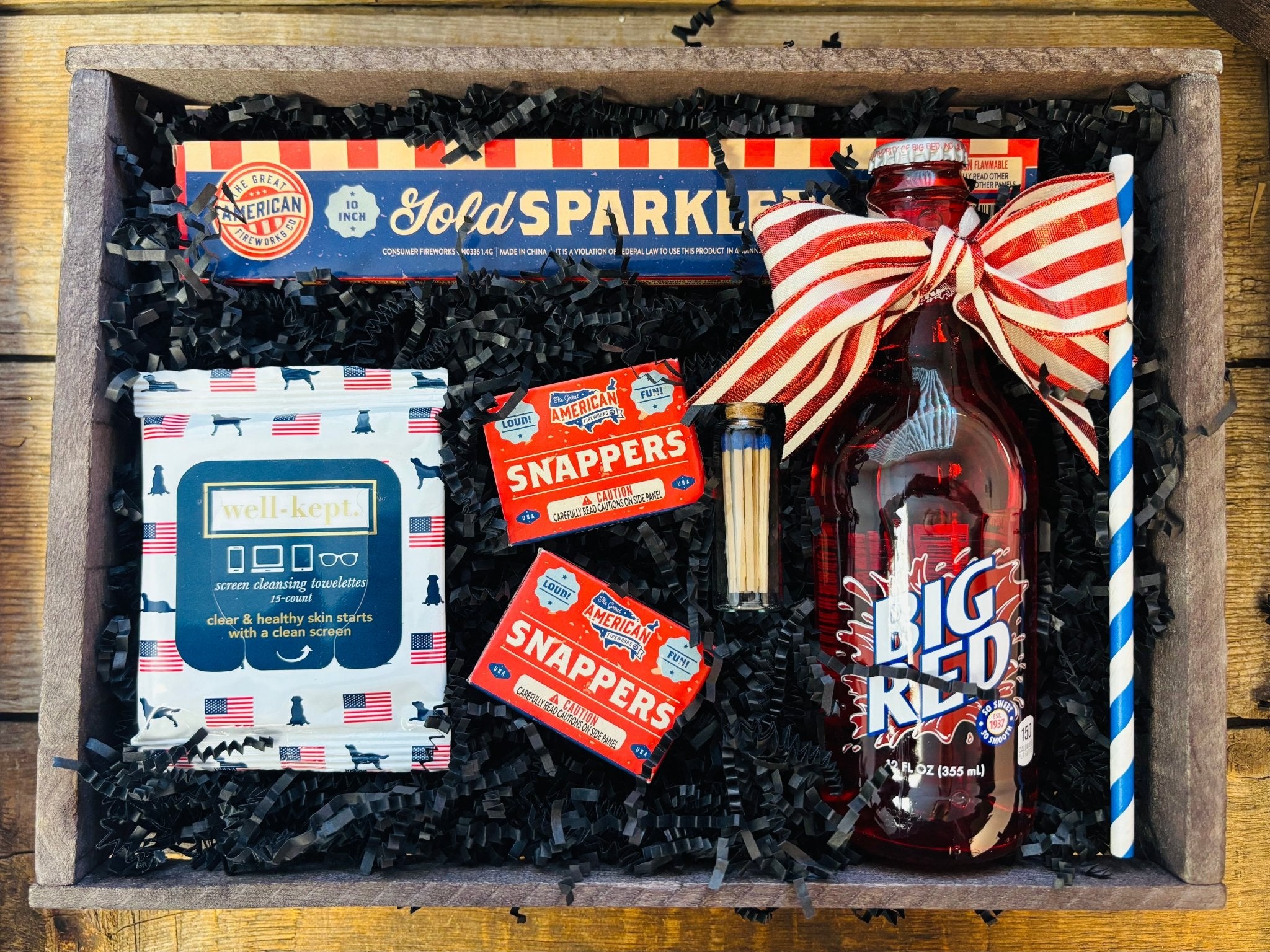 Nifty Package Co. Vintage Americana Patriotic Gift Basket featuring Big Red soda, sparklers, snappers, and matches in a rustic wooden crate as seen in Patriotic Gift 3.jpg